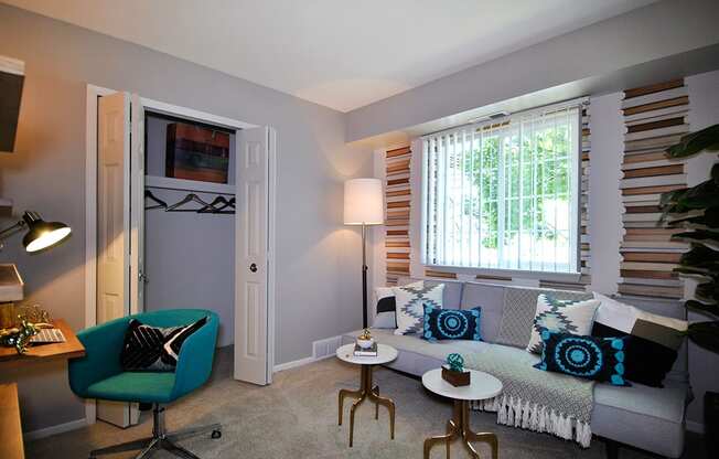 a living room with a couch and a window at Village Club of Rochester Hills, Shelby Township, MI