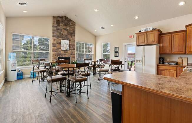 the kitchen and dining area of a home with a table and chairs