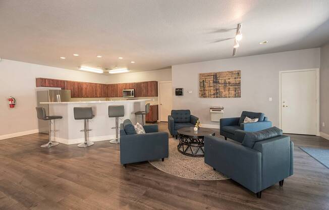 A living room with grey couches and a bar area at Autumn Oaks Apartments, Roseville, CA, 95678