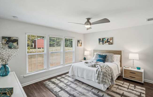 a bedroom with a bed and a ceiling fan