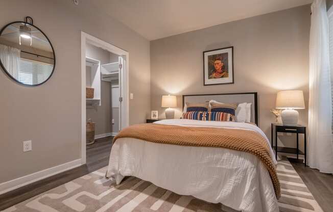 a bedroom with a bed and a door to a bathroom