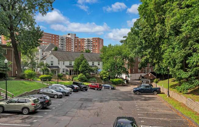 a city street with cars parked in a parking lot