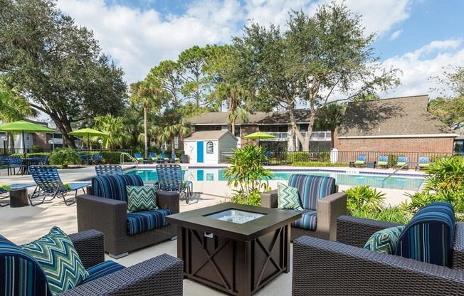 a pool with lounge chairs and a table