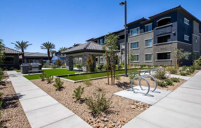 Community area with bike rack, bocce ball court, gas BBQ grills, and ramada..