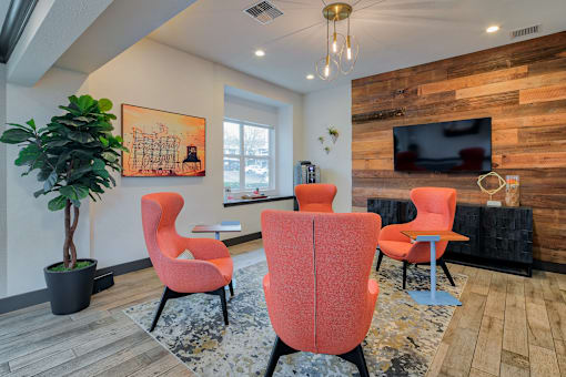 A living room with a wooden wall and a television.