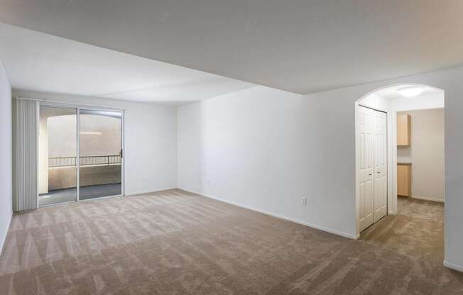 A room with a carpeted floor and a doorway leading to another room. at La Jolla Crossroads Apartments, California, 92122