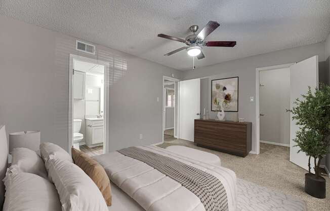 A bedroom with a bed, dresser, and mirror.