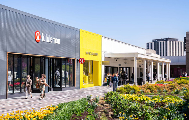 A storefront with a red logo that says "lululemon" on it.