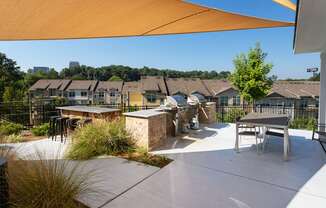 A sunny day at a residential area with houses and a patio.