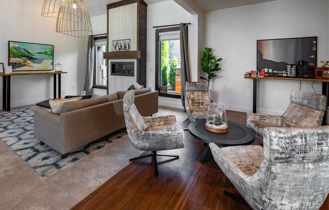 a living room with couches and chairs and a tv