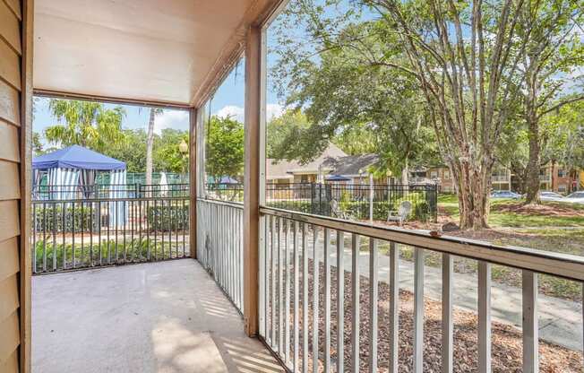 A view from a balcony looking out at a playground and houses.