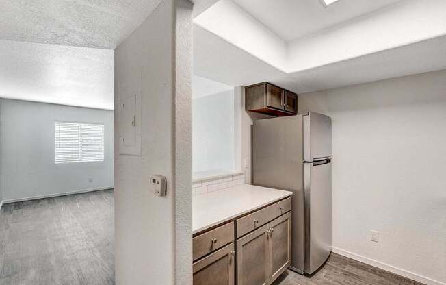 A kitchen with a refrigerator and a countertop.