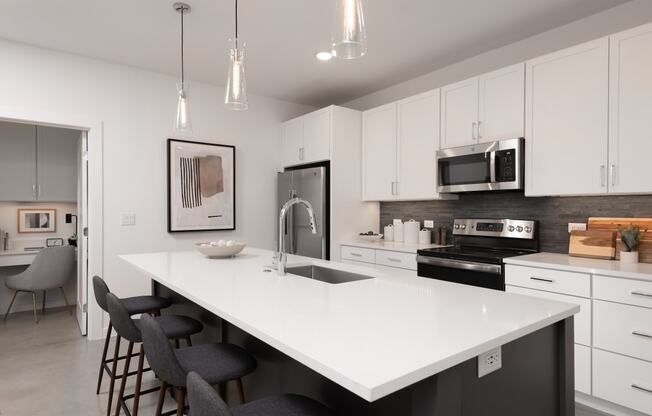 an open kitchen with a large white counter top