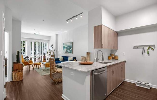 A modern kitchen with a large island and wooden floors.