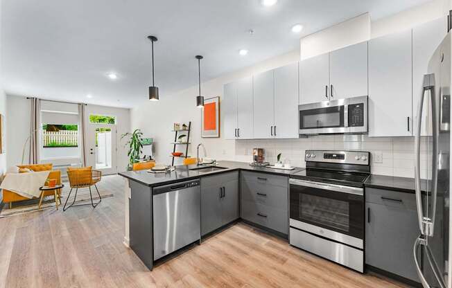 A modern kitchen with stainless steel appliances and wooden flooring.at 829 Garfield, Jersey City