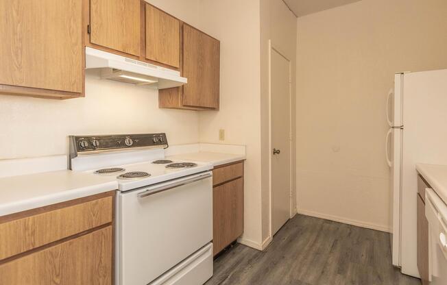 a kitchen with a stove and a refrigerator