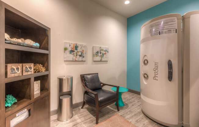 a room with a chair and tanning bed