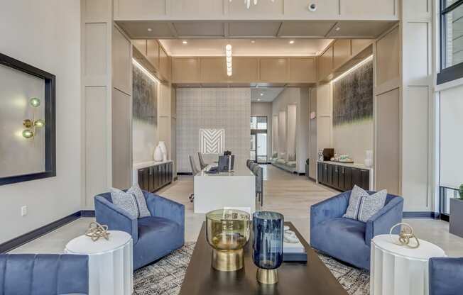 a living room with blue couches and a table