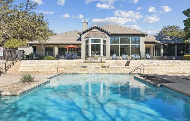 a pool with a house in the background