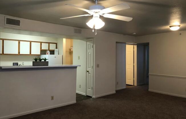 an empty living room with a ceiling fan at GABLE HILLS Apartments, TULSA, OK