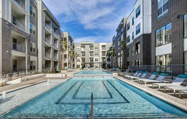 Austin Luxury Apartments - Arise Riverside - Sparking Pool With Lounge Chairs And A Sundeck. Pool Is In The Heart Of The Apartment Complex.