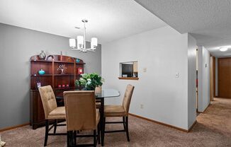 a dining room with a table and chairs