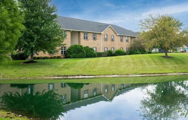 One-Bedroom Apartments in Canal Winchester, OH - The Coleman - Building Exterior with Beautiful Landscaping and a Pond