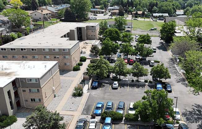 A parking lot with cars and a building in the background.