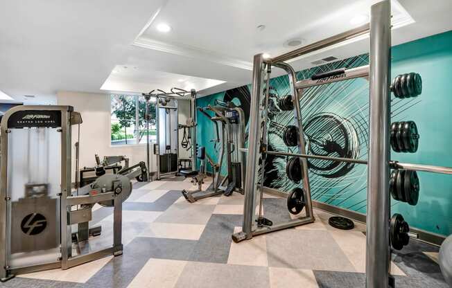 a home gym with a turquoise wall and a checkered floor  at Apex Mission Valley, San Diego, California