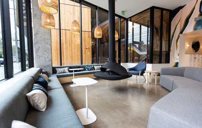 a living room with couches and chairs and a fireplace