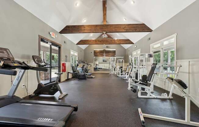 A gym with treadmills, weights, and exercise equipment.
