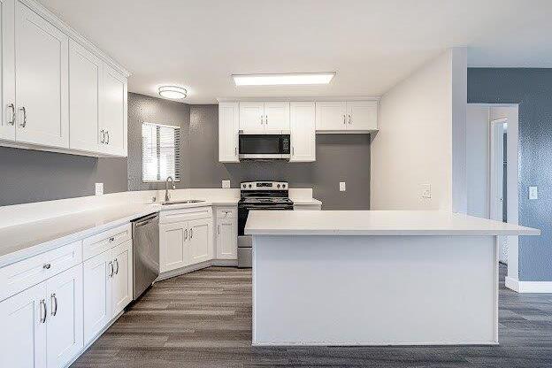 A modern kitchen with white cabinets and a large island.