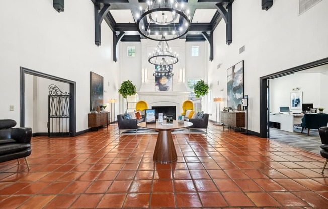 a large living room with a fireplace and a large chandelier