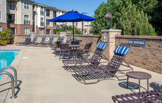 A pool area with chairs and a sign that says "No Diving".