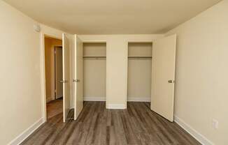 A room with a wooden floor and white walls.