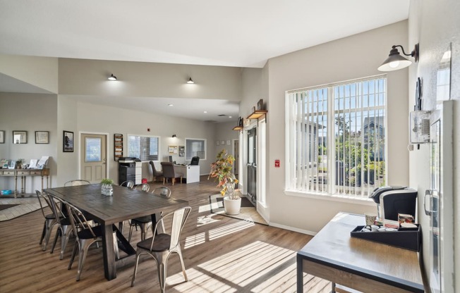 an open living room and dining room with a large window