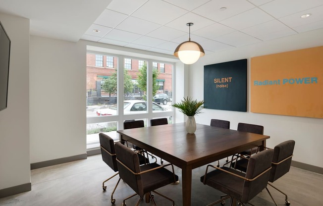 A conference room with a long table and chairs.