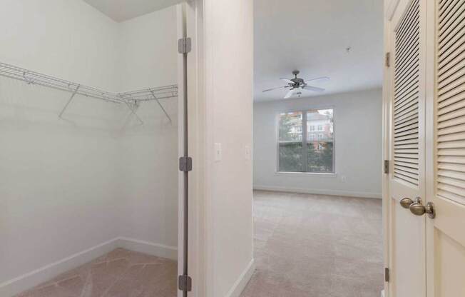 a bedroom with a closet and a ceiling fan