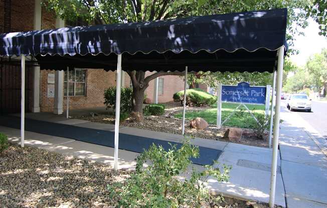 a blue awning in front of a brick building