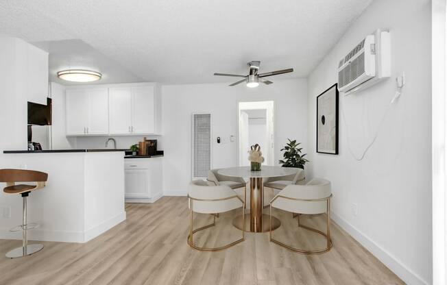 an open kitchen and dining room with a table and chairs