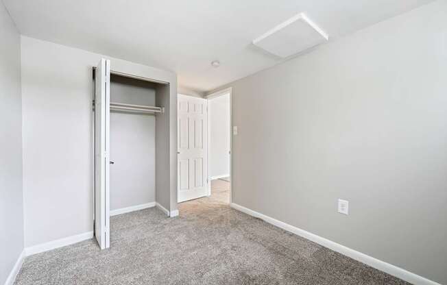 a bedroom with a closet and a door at ReNew Odenton