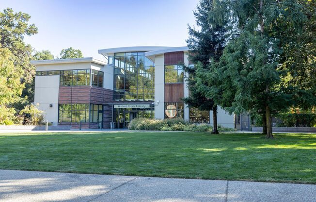 a building with a lawn and trees in front of it