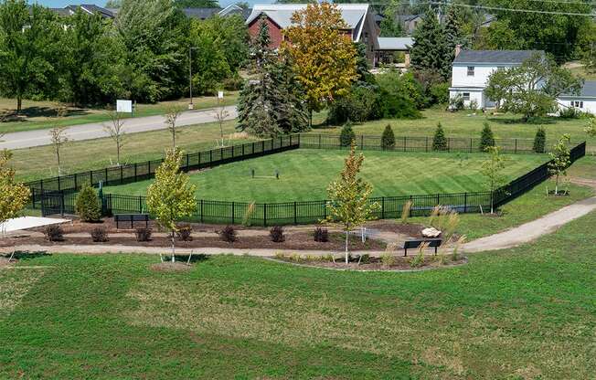 an aerial view of a park with a baseball field and trees