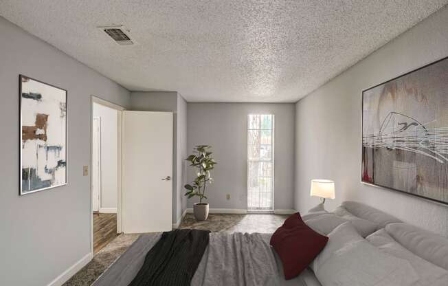 the master bedroom has a large bed and a sliding door to the living room