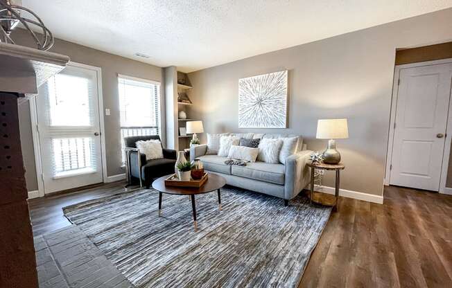 an open living room with a couch and a rug