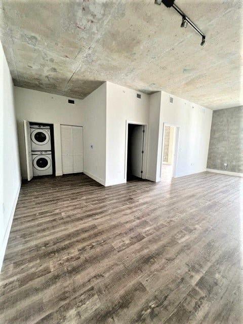 an empty living room with white walls and wood floors