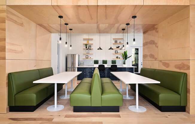 a modern living room with green couches and a white table at Sovereign at Overland Park, Kansas  