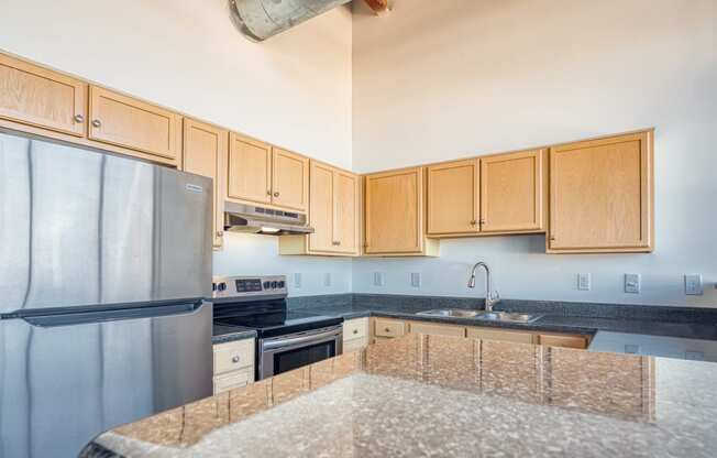 a kitchen with granite counter tops and stainless steel appliances