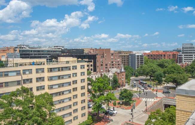 an aerial view of a city street with buildings and trees