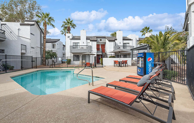 Community Swimming Pool with Pool Furniture at Crystal Creek Apartments in Phoenix, AZ.